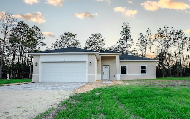 view of front of house featuring a lawn and a garage