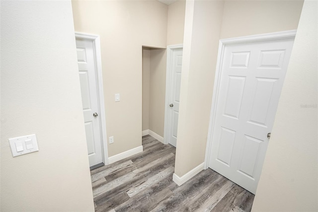 corridor with hardwood / wood-style floors