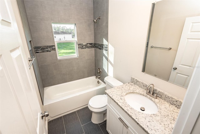 full bathroom featuring vanity, toilet, and tiled shower / bath