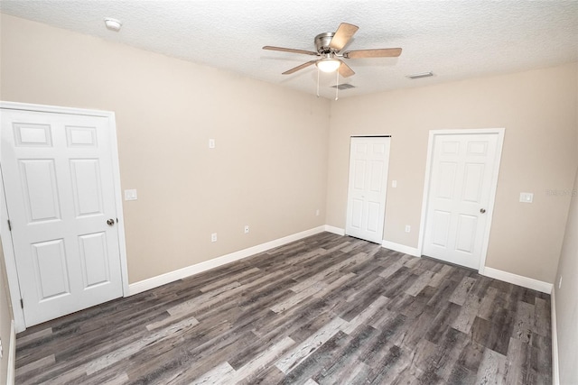 unfurnished bedroom with a textured ceiling, ceiling fan, and dark hardwood / wood-style floors