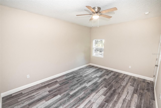 spare room featuring ceiling fan, dark hardwood / wood-style flooring, and a textured ceiling