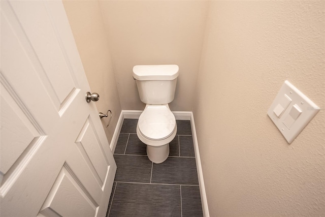 bathroom featuring tile patterned floors and toilet