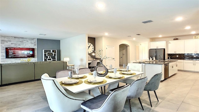 dining space featuring light tile patterned floors and sink