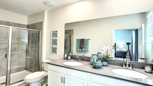 bathroom featuring vanity, toilet, and an enclosed shower