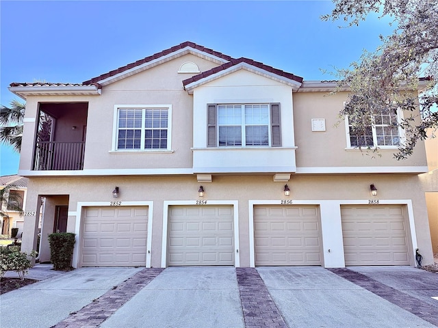 multi unit property with a balcony and a garage