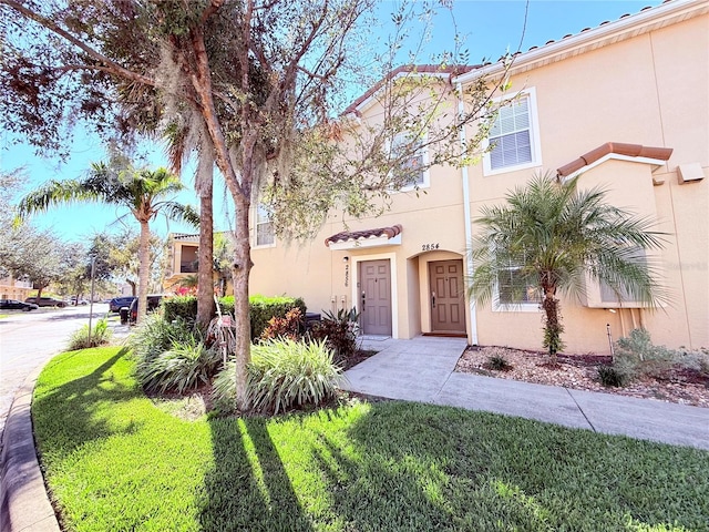 mediterranean / spanish-style house featuring a front lawn