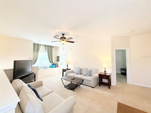 living room featuring light colored carpet and ceiling fan