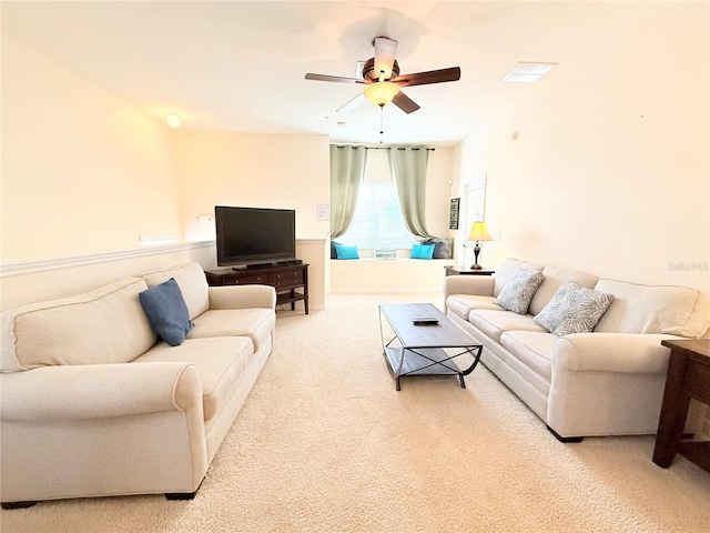 carpeted living room with ceiling fan