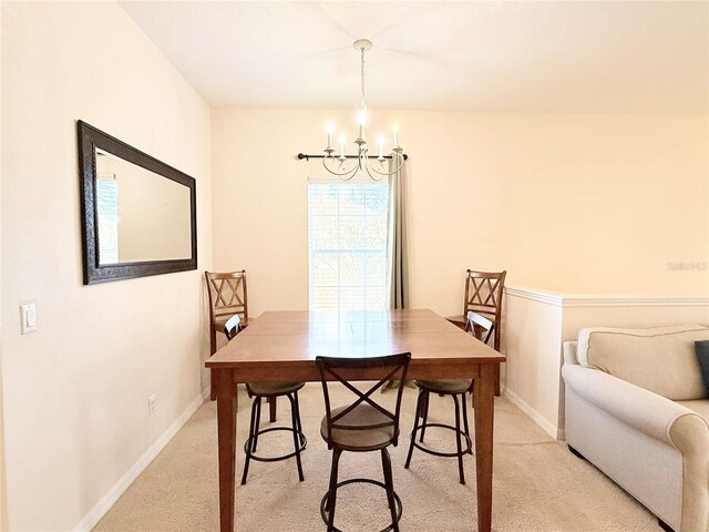 2856 Oakwater Dr Unit 2856, Kissimmee, FL 34747 - dining area with a chandelier, light carpet, and baseboards