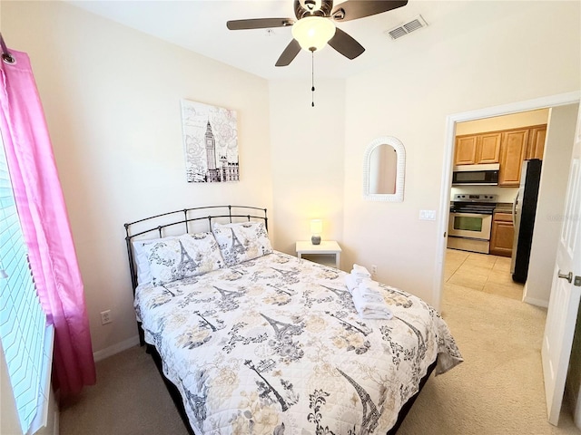 bedroom featuring light colored carpet, stainless steel refrigerator, and ceiling fan