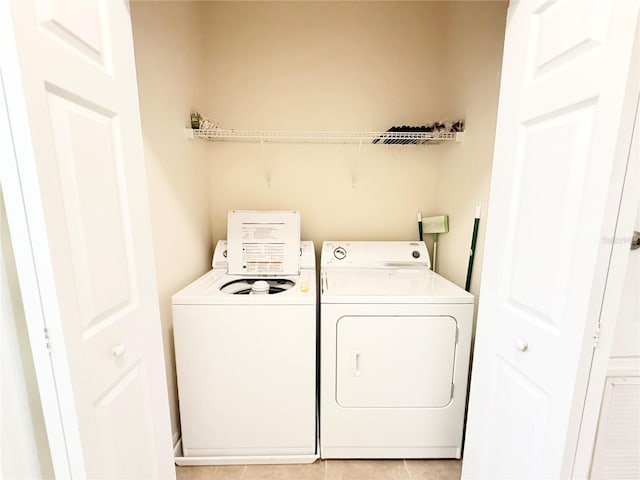 washroom featuring light tile patterned floors and washing machine and dryer