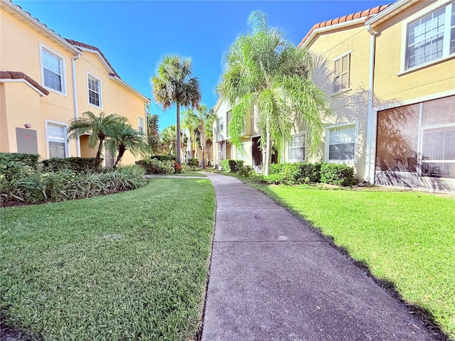 view of property's community with a yard