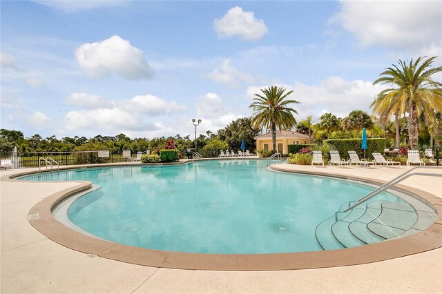 2856 Oakwater Dr Unit 2856, Kissimmee, FL 34747 - community pool featuring a patio