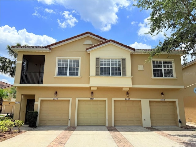 2856 Oakwater Dr Unit 2856, Kissimmee, FL 34747 - view of property featuring stucco siding and a tiled roof