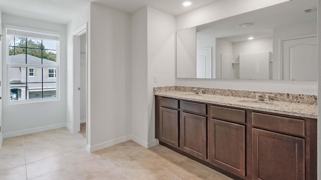 bathroom featuring tile patterned flooring and vanity