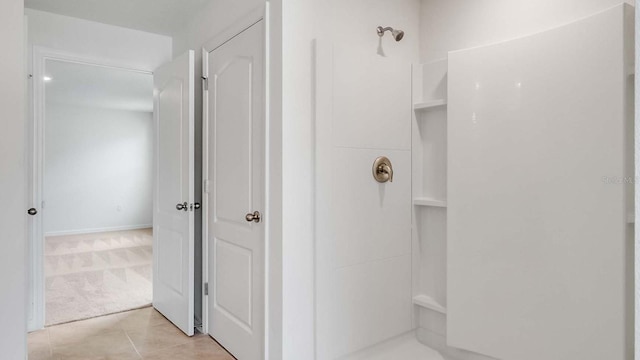 bathroom with tile patterned flooring and walk in shower