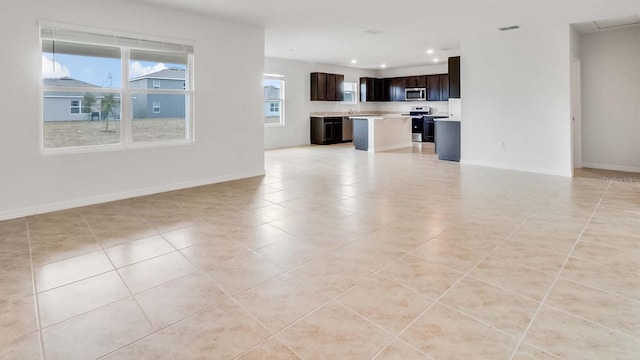 unfurnished living room with light tile patterned floors