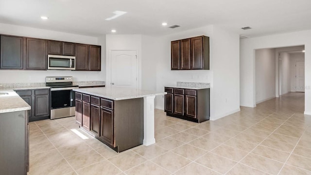 kitchen with a center island, dark brown cabinetry, and stainless steel appliances