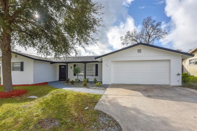 ranch-style house featuring a front lawn and a garage