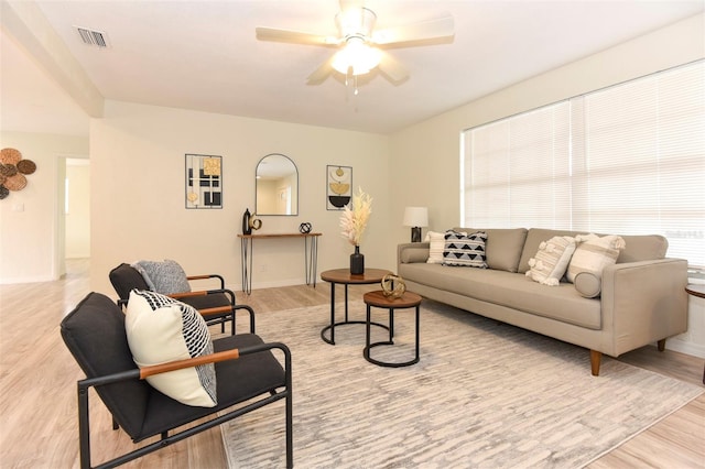 living room with ceiling fan and light hardwood / wood-style floors