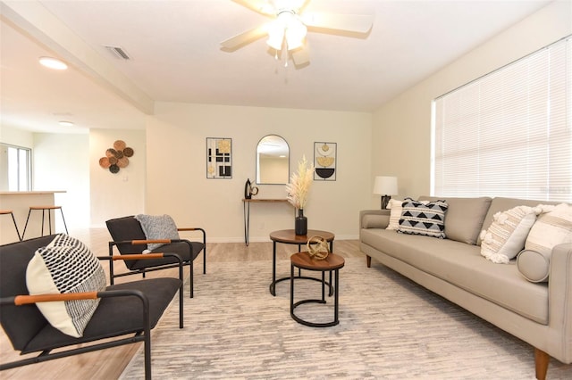 living room with ceiling fan and light hardwood / wood-style floors