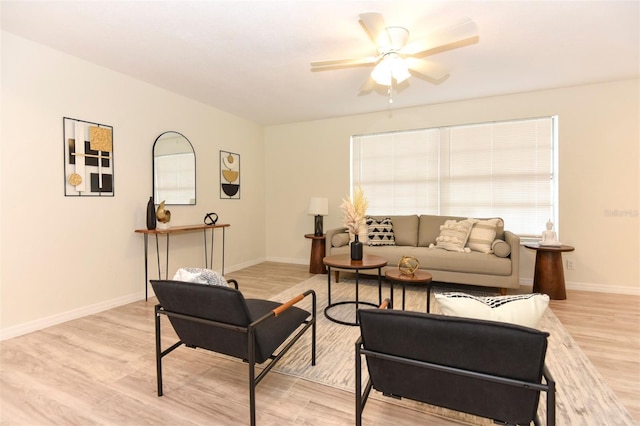 living room featuring ceiling fan and light hardwood / wood-style flooring