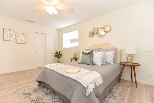 bedroom featuring ceiling fan, light hardwood / wood-style floors, and a closet