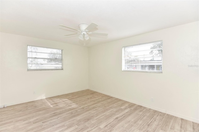 unfurnished room featuring light wood-type flooring and plenty of natural light