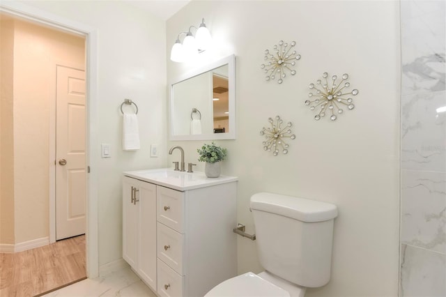 bathroom featuring vanity, hardwood / wood-style flooring, and toilet