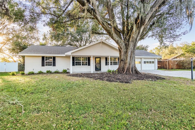 ranch-style house featuring a garage and a front lawn