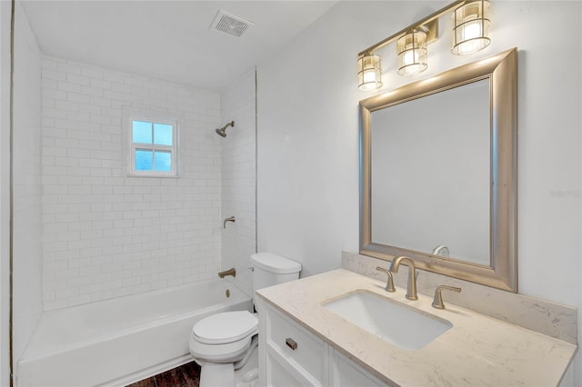 full bathroom with hardwood / wood-style flooring, vanity, toilet, and tiled shower / bath