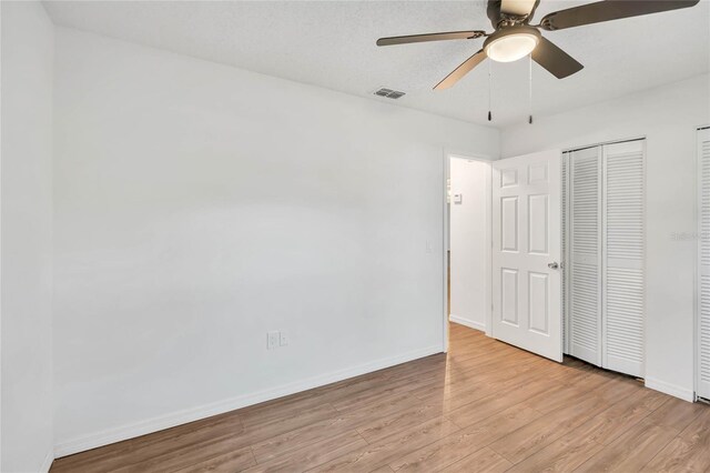 unfurnished bedroom featuring light hardwood / wood-style flooring and ceiling fan