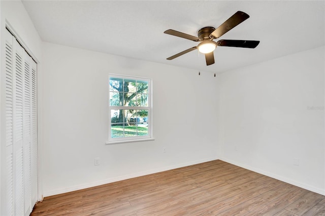 unfurnished bedroom featuring ceiling fan, a closet, and light hardwood / wood-style flooring