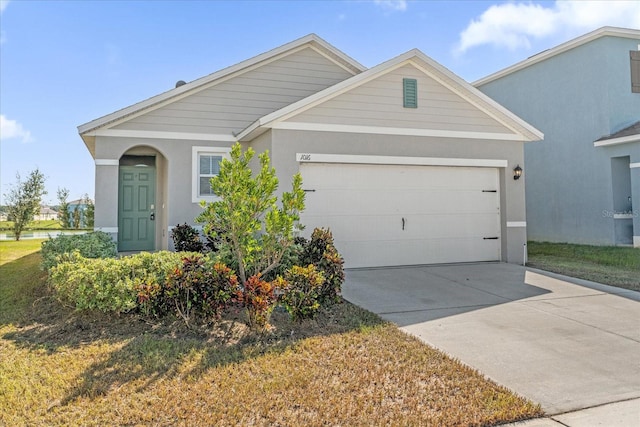 view of front of home featuring a garage and a front yard