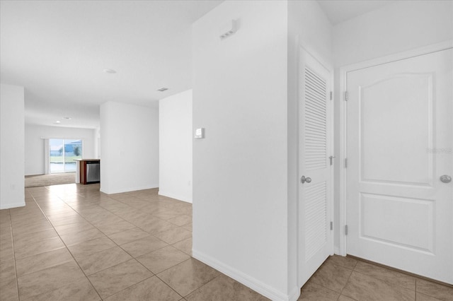 hallway featuring light tile patterned floors