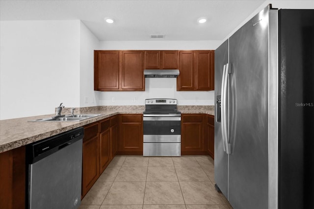 kitchen featuring light tile patterned floors, stainless steel appliances, and sink