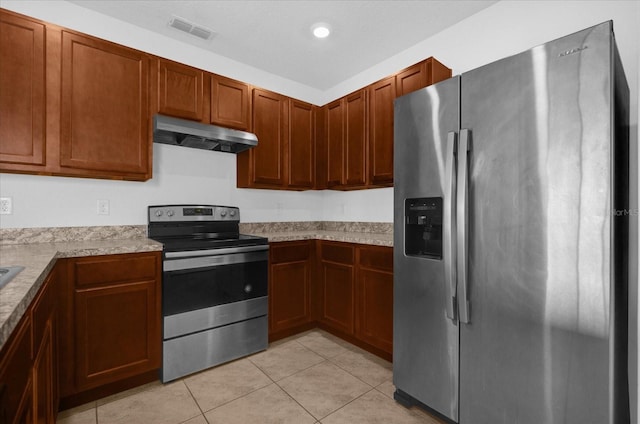 kitchen with light tile patterned floors and stainless steel appliances