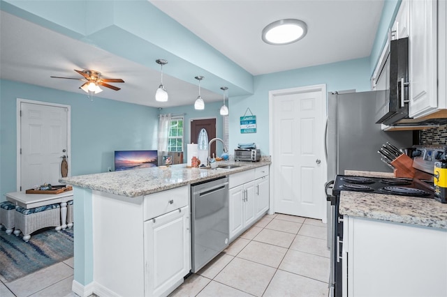 kitchen with hanging light fixtures, white cabinets, stainless steel appliances, and sink