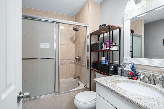 full bathroom with vanity, toilet, and enclosed tub / shower combo