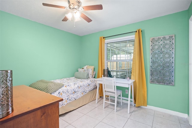 tiled bedroom featuring ceiling fan