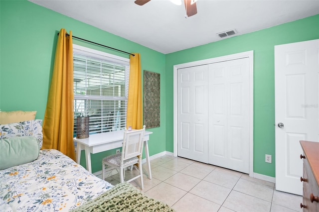 bedroom featuring ceiling fan, a closet, and light tile patterned floors