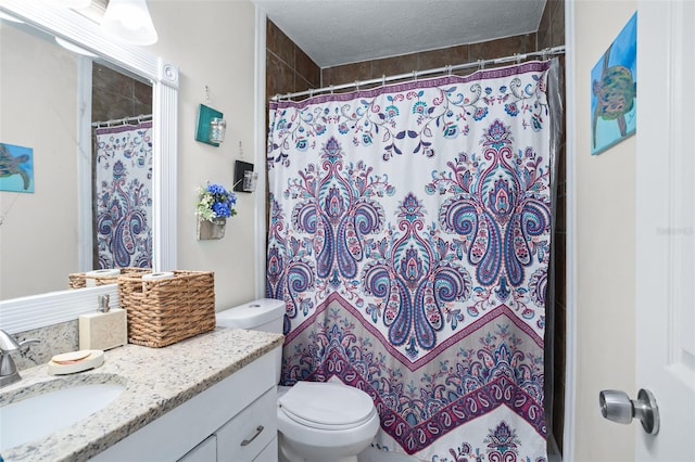 bathroom featuring a shower with curtain, vanity, a textured ceiling, and toilet