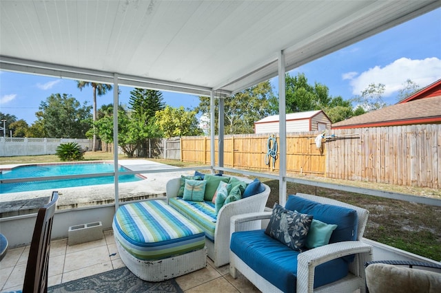 exterior space featuring an outdoor living space and a fenced in pool