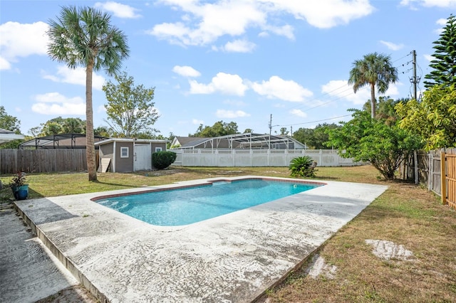 view of swimming pool featuring a storage shed and a yard