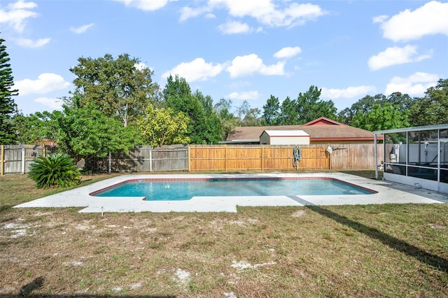 view of pool with a sunroom and a lawn