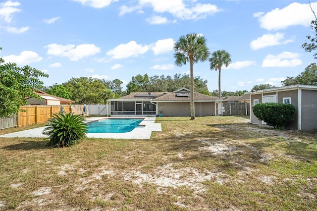 view of pool with a sunroom and a yard