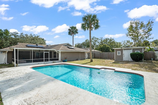 view of pool with a sunroom, a storage unit, and a yard