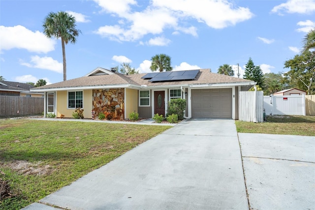 single story home featuring a front lawn, a garage, and solar panels