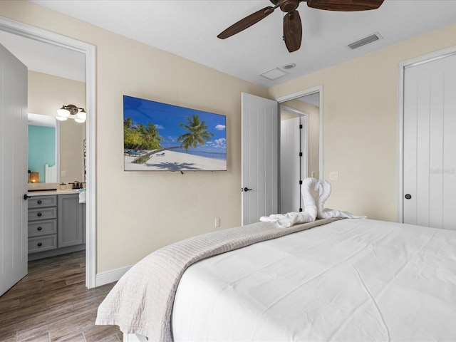 bedroom featuring wood-type flooring, ensuite bathroom, and ceiling fan