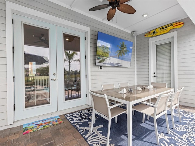 sunroom / solarium featuring ceiling fan and french doors